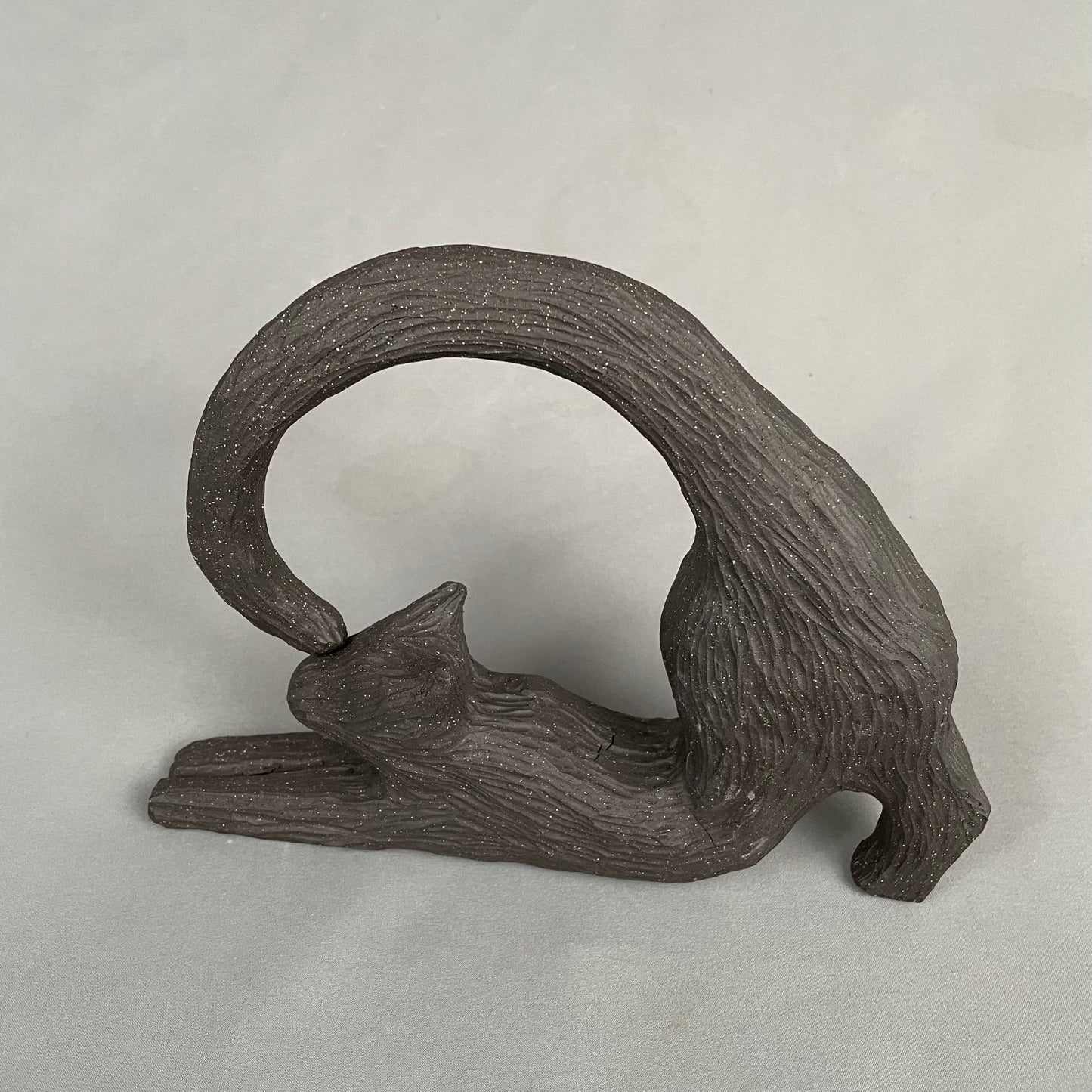 cat with curled tail sculpture