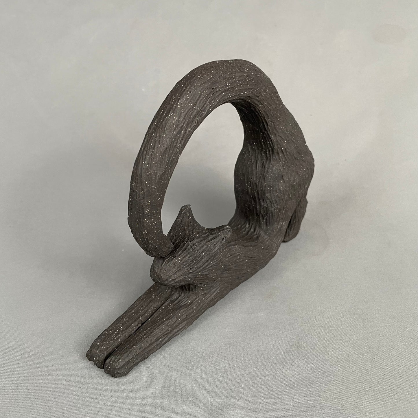 cat with curled tail sculpture