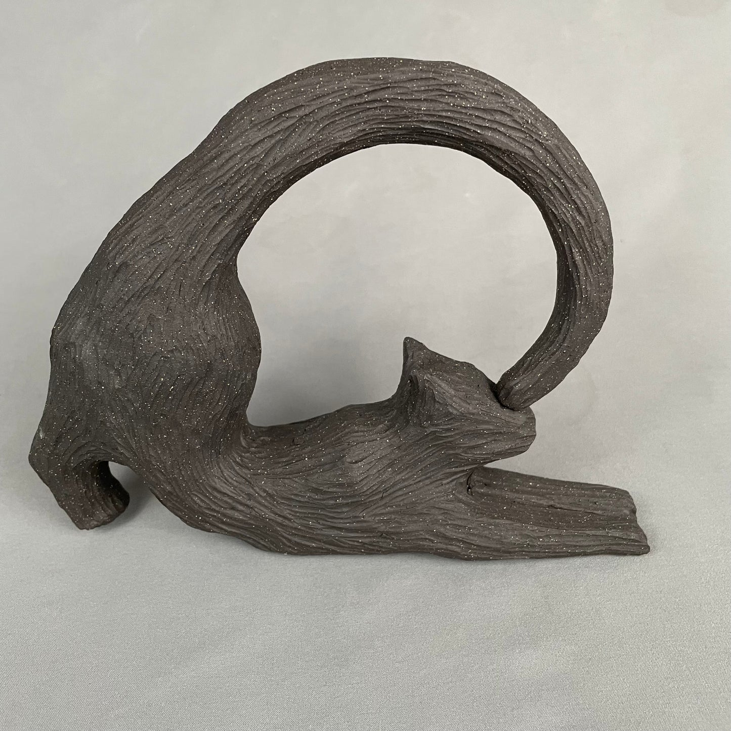 cat with curled tail sculpture