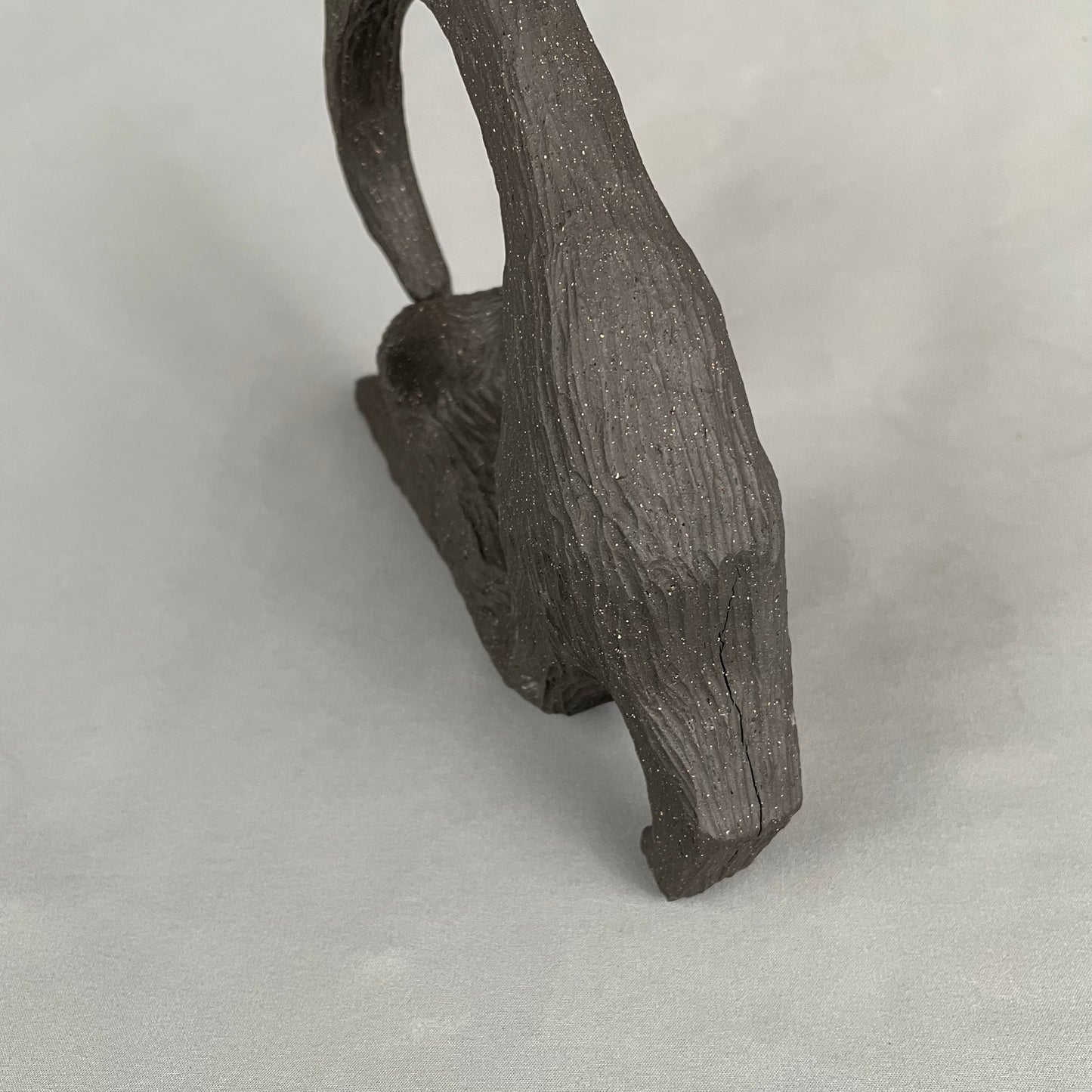 cat with curled tail sculpture